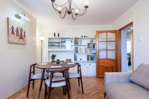 a living room with a table and chairs and a couch at Kora Apartment in Kończyce Małe