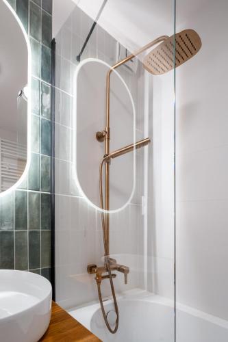 a bathroom with a shower and a sink at Kora Apartment in Kończyce Małe