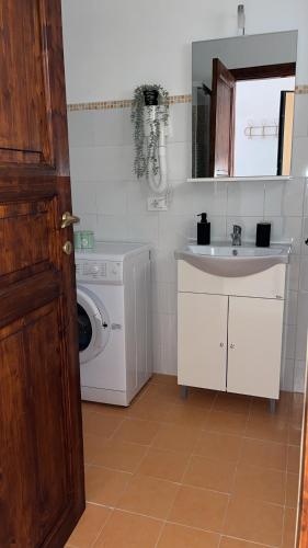 un bagno con lavatrice e lavandino di Paradiso sul lago a Valle Verde