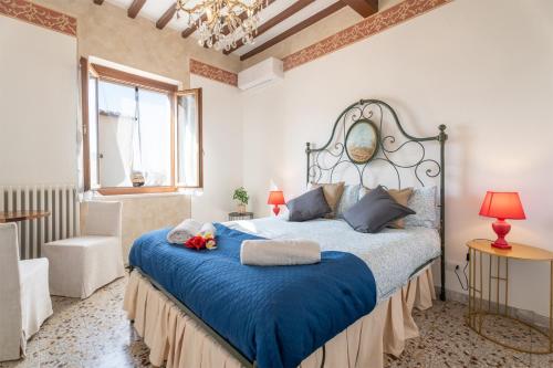 a bedroom with a large bed with a blue blanket at Urban Center Arezzo in Arezzo