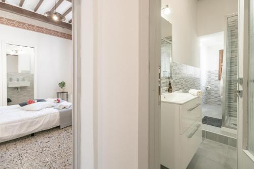 a white bathroom with a bed and a sink at Urban Center Arezzo in Arezzo