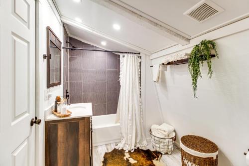 a bathroom with a sink and a bath tub at Deck and Grill Cozy Cottage in Talking Rock! in Talking Rock