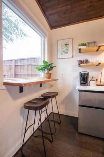 a kitchen with two stools and a counter and a window at Charming Studio in Taylors by Brick and Home in Taylors