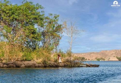 a person standing on a small island in the water at البيت النوبى in Aswan