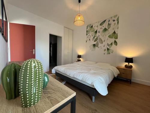 a bedroom with a bed and a table and a couch at Appartement 48 m2 neuf 150m de la mer A307 in Royan