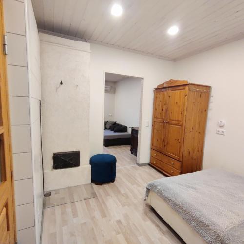 a bedroom with a bed and a wooden cabinet at Suure terrassiga korter raudteejaama lähedal in Viljandi