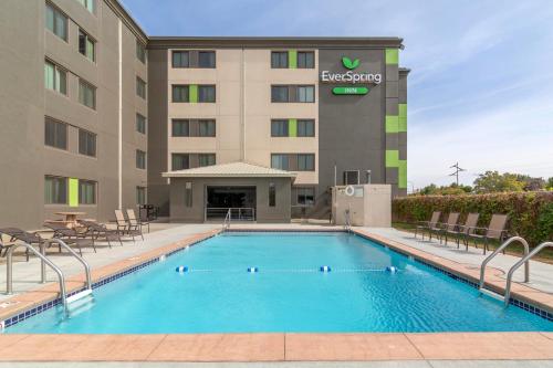 a hotel with a swimming pool in front of a building at EverSpring Inn in Bismarck