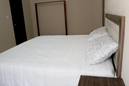 Ein Bett oder Betten in einem Zimmer der Unterkunft Hotel Casa Hidalgo