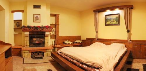 a bedroom with a bed and a fireplace at Svit Sontsya in Turʼya Polyana