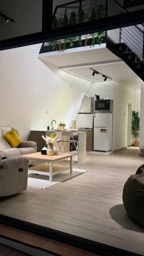 a living room with a couch and a table at sandhut77 in Al Raka