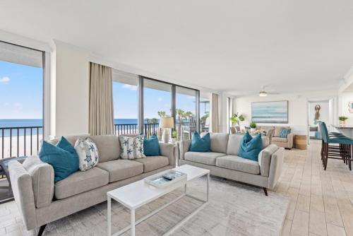 a living room with two couches and a table at Sandpiper Beacon Beach Resort in Panama City Beach