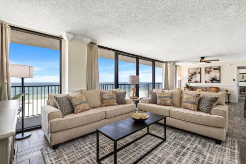 a living room with a couch and a table at Sandpiper Beacon Beach Resort in Panama City Beach