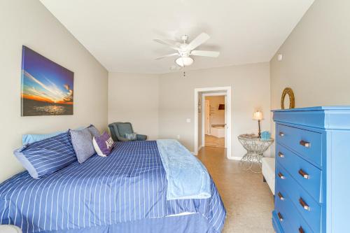a bedroom with a blue bed and a ceiling fan at Fire Pit and Stunning Views Lake Eufaula Retreat! in Texanna