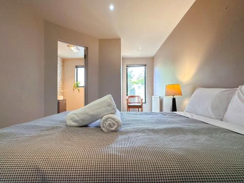 a bedroom with a large bed with a pillow on it at Apartment On Star Unit 1 in Sandy Bay