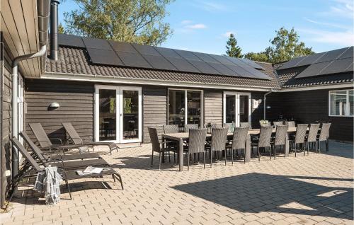 a house with a table and chairs with solar panels on it at Gorgeous Home In Frederiksværk in Frederiksværk