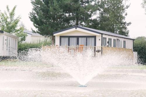 a fire hydrant spraying water in front of a house at St Andrews Dreams, luxury times! in Wisbech