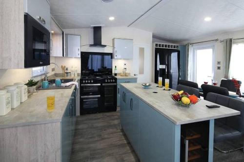 a kitchen with a counter with a bowl of fruit on it at St Andrews Dreams, luxury times! in Wisbech