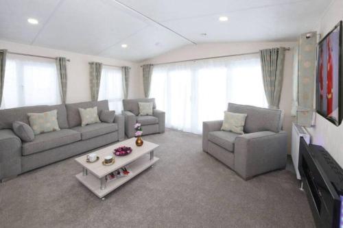 a living room with a couch and a coffee table at St Andrews Dreams, luxury times! in Wisbech