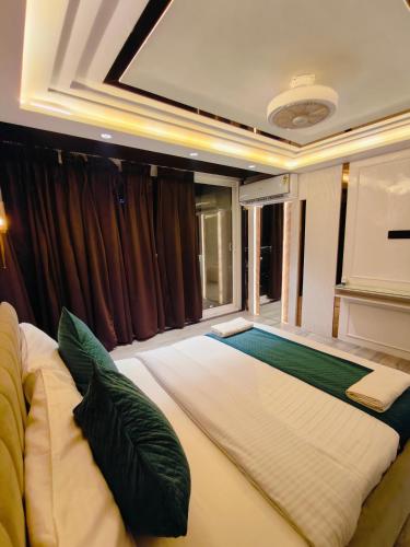 a large bed in a room with a window at The Vacation Villa in Agra