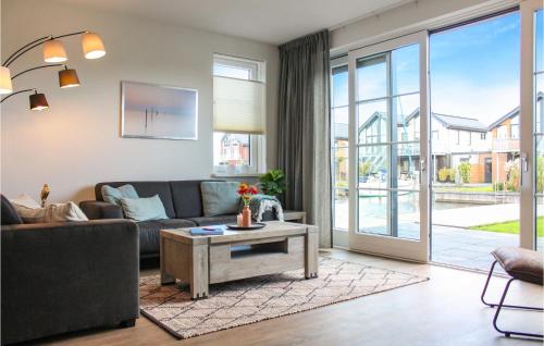 a living room with a couch and a table at Cozy Home In Stavoren With Wifi in Stavoren