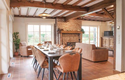 a dining room with a long table and chairs at 4 Bedroom Gorgeous Home In Groede in Groede