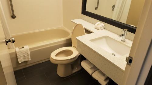 a bathroom with a white toilet and a sink at Red Roof Inn Port Allen in Port Allen