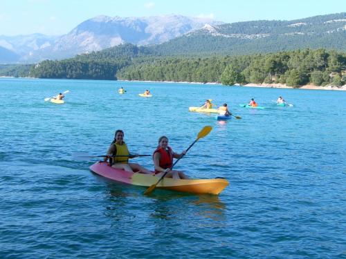two women are sitting on a kayak in the water at Casas Cueva Cazorla in Hinojares