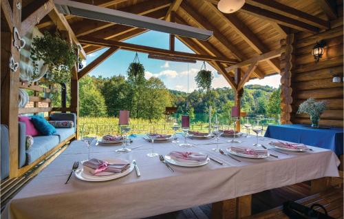 a table with plates and napkins on top at Beautiful Home In Gornji Zvecaj in Gornji Zvečaj