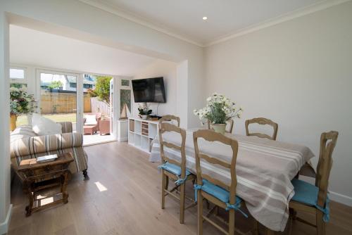 a bedroom with a bed and a living room at Meadow Drive in Bembridge