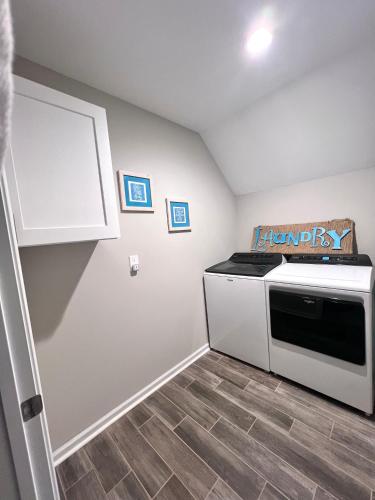 a kitchen with a stove and a microwave at Rest Easy in North Carolina in Denver