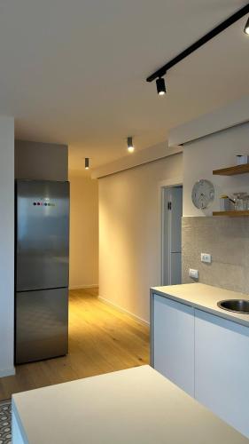 a kitchen with a refrigerator and a counter top at The Comfy Nest - Parking, King Size Bed, Smart Tv in Cluj-Napoca