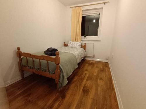 a small bedroom with a bed and a window at Sheffield Serenity in Heeley