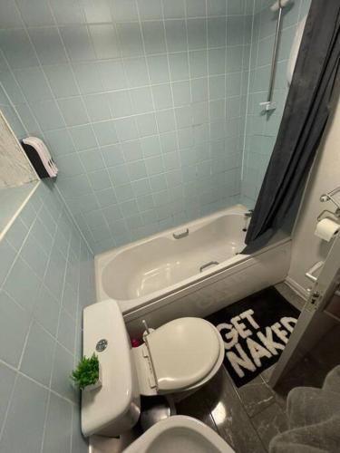 a bathroom with a toilet and a bath tub at Sheffield Serenity in Heeley