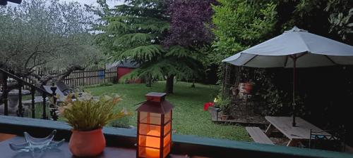 a patio with an umbrella and a table with a candle at La Casita del Río in Sabando