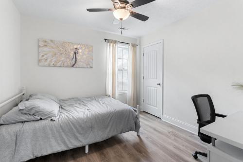 a bedroom with a bed and a ceiling fan at The Gate 4 Getaway! in Oak Grove
