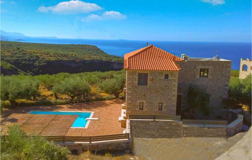 a building with a swimming pool next to the ocean at Maison Elia With Private Pool in Kardamili