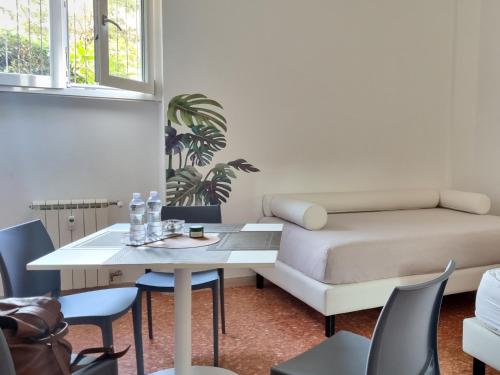 a room with a bed and a table and chairs at BAM BAM TIBURTINA Guesthouse in Rome