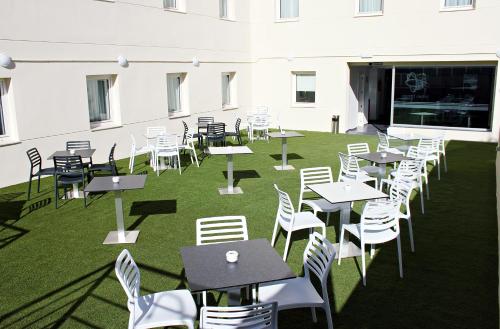 a group of tables and chairs in a building at Checkin Urban Nevada in Granada