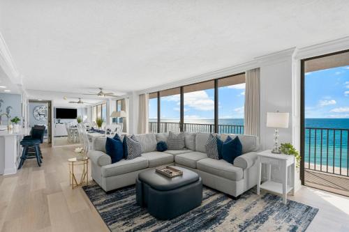 a living room with a couch and a table at Sandpiper Beacon Beach Resort in Panama City Beach