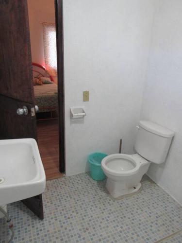 a bathroom with a white toilet and a sink at surf la bamba in Dolores Miramar