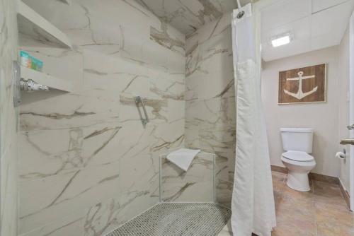 a bathroom with a marble shower with a toilet at WINTER RATES! Impeccable Oceanfront Suite, Top Floor! L1543 in Myrtle Beach