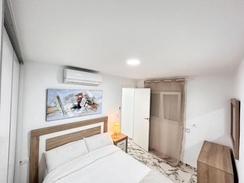 a bedroom with a bed and a picture on the wall at Apartamento Noori 1B in Vinaròs