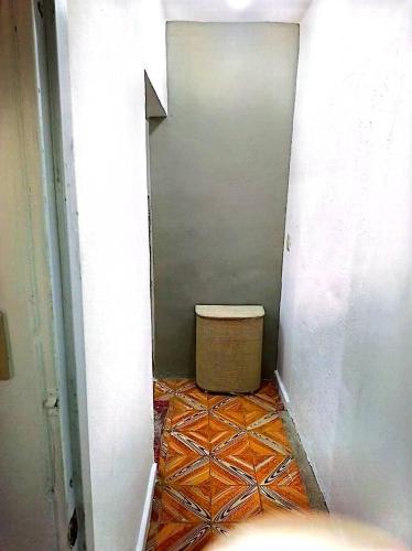 a hallway with a room with a trashcan in it at Bchome hostal in Boca Chica