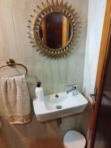 a bathroom with a sink and a mirror at CASA GONDAR in O Grove