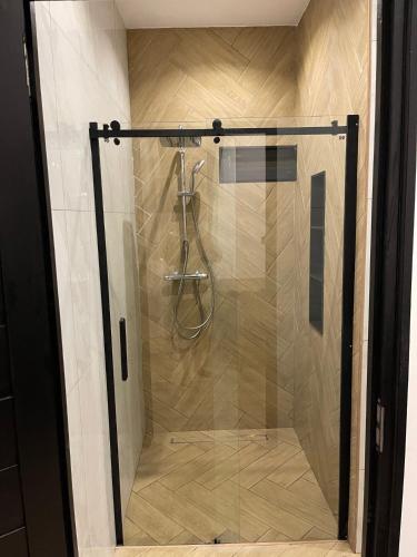 a shower with a glass door in a bathroom at Boa vista appartementen in Paramaribo