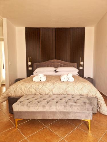 a bedroom with a bed with two white bows on it at La Corte dei Filangieri in Candida