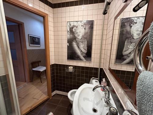 ein Badezimmer mit Toilette, Waschbecken und Spiegel in der Unterkunft Apartment Stepana Bandery Street in Riwne