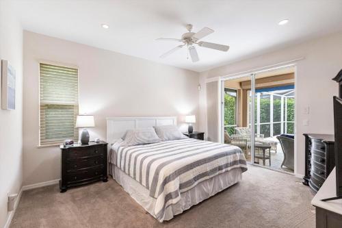 a bedroom with a bed and a ceiling fan at Marco Home - 3BR - Pet Friendly - Pool & Lanai in Marco Island