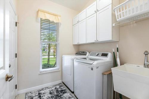 a white laundry room with a washer and dryer at Marco Home - 3BR - Pet Friendly - Pool & Lanai in Marco Island