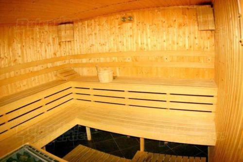 a small wooden sauna with a bench in it at Top location unique apartment in Bansko